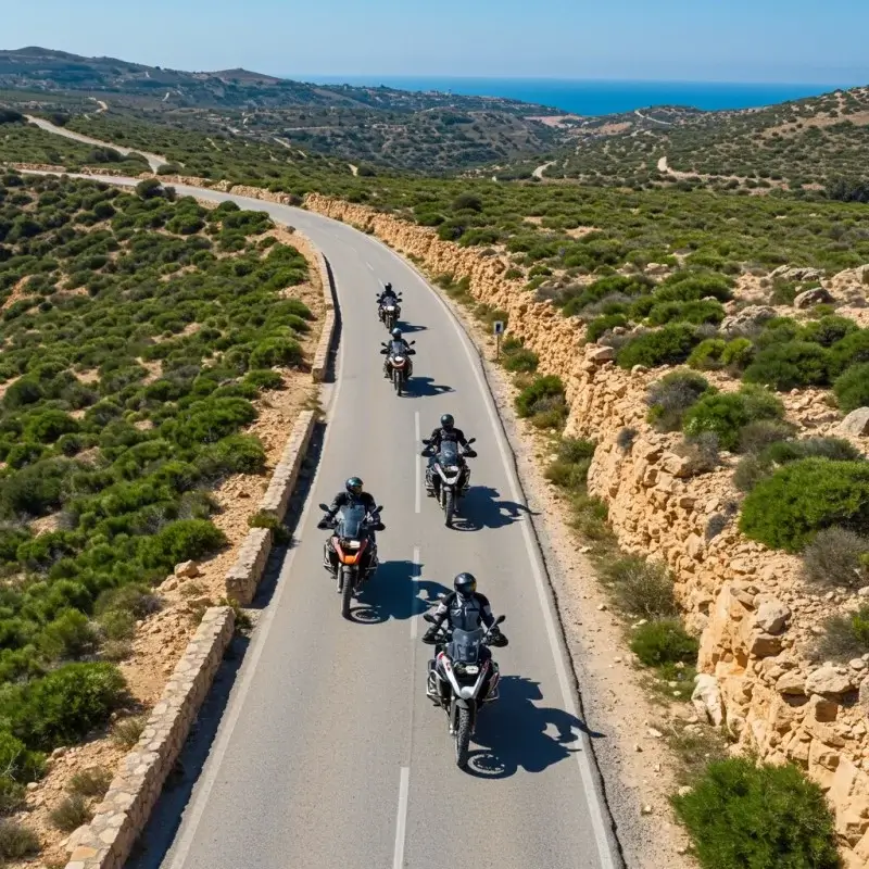 A group of people enjoying a guided motorcycle tour through a scenic landscape.