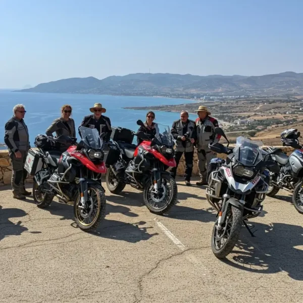 Motorcycle tour group enjoying a break with a panoramic coastal view