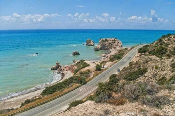 Riding along the coast towards Aphrodite's Rock on a motorcycle tour in Cyprus