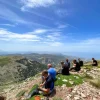 Riders taking a break on a Greek off-road adventure motorcycle trip
