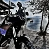A Yamaha Tenere with the sea and Greek flag in the background